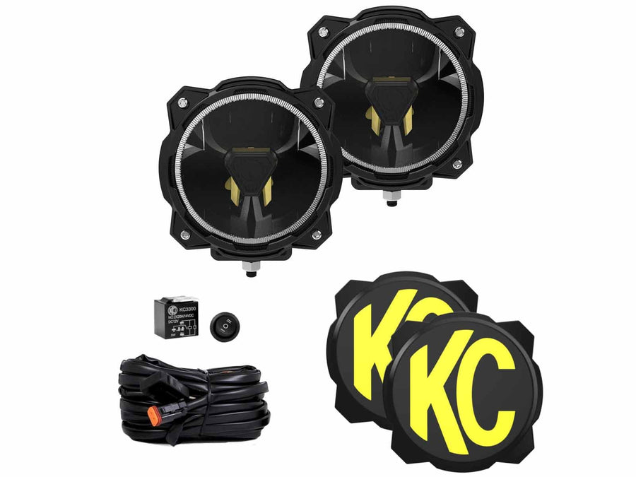 Gravity Titan LED Lights by KC HiLiTES: Two round black LED off-road lights with halo rings, two black and yellow KC covers, a wiring harness, a relay and a rocker switch