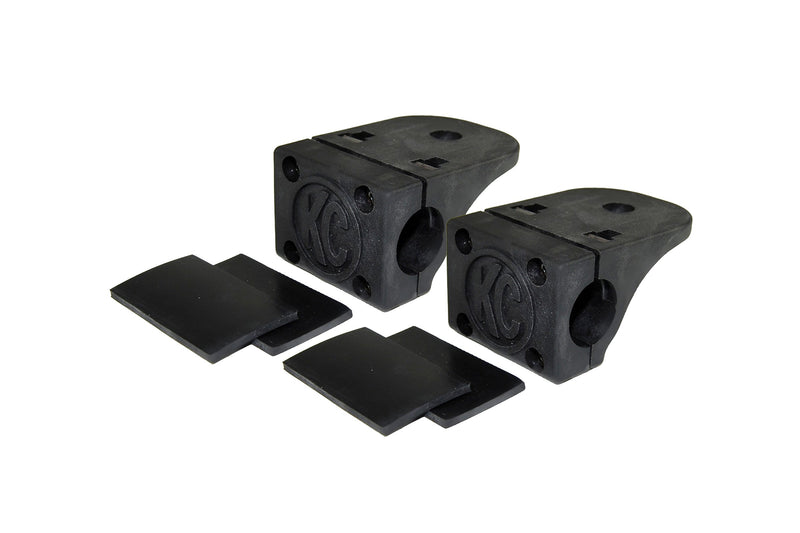 KC HiLiTES Tube Clamp Light Mount on a studio background: pair of black KC tube clamp light mounts, each with two black rubber adjustment shims on a white background