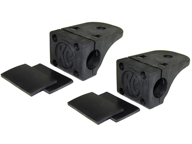 KC HiLiTES Tube Clamp Light Mount on a studio background: pair of black KC tube clamp light mounts, each with two black rubber adjustment shims on a white background