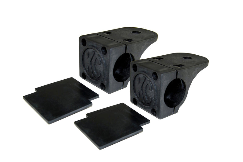 KC HiLiTES Tube Clamp Light Mount on a studio background: pair of black KC tube clamp light mounts, each with two black rubber adjustment shims on a white background