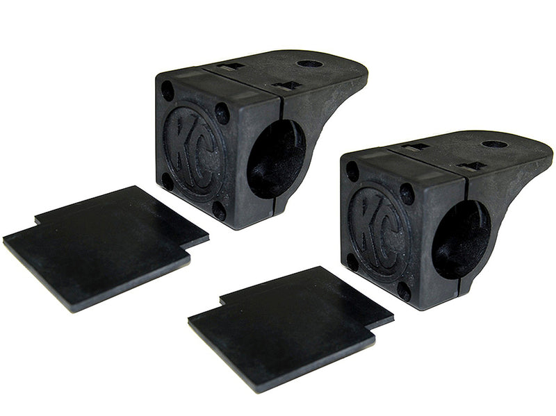 KC HiLiTES Tube Clamp Light Mount on a studio background: pair of black KC tube clamp light mounts, each with two black rubber adjustment shims on a white background