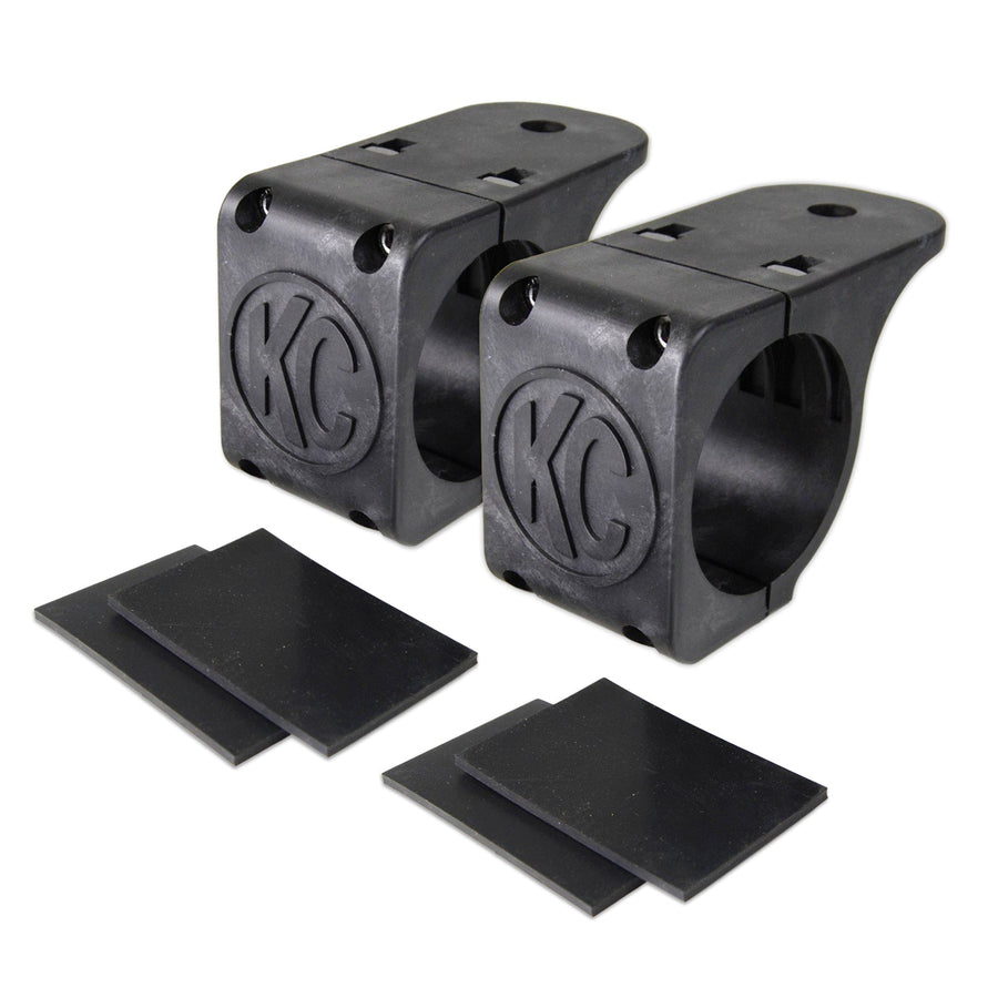 KC HiLiTES Tube Clamp Light Mount on a studio background: pair of black KC tube clamp light mounts, each with two black rubber adjustment shims on a white background