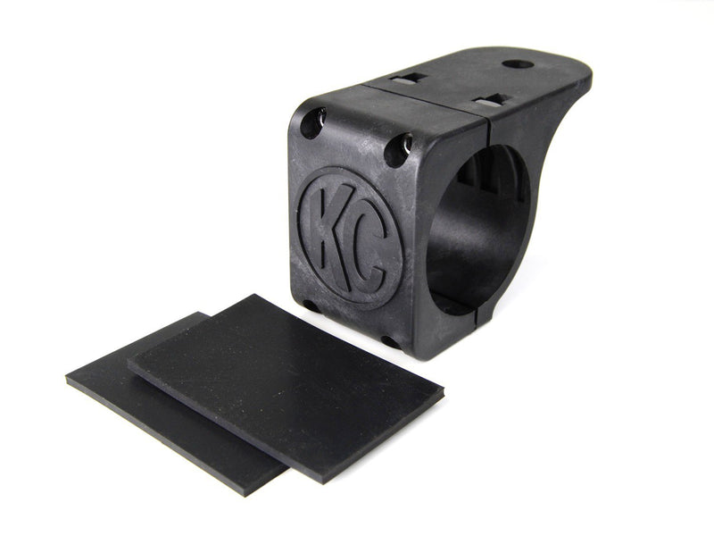 KC HiLiTES Tube Clamp Light Mount on a studio background: single black KC tube clamp light mount with two black rubber adjustment shims on a white background