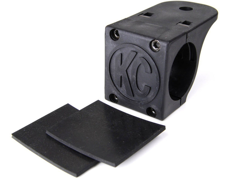 KC HiLiTES Tube Clamp Light Mount on a studio background: single black KC tube clamp light mount with two black rubber adjustment shims on a white background