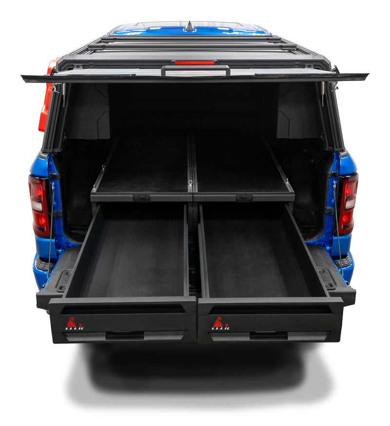LEER NexStor truck bed drawer unit on a pickup bed: rear view of a blue pickup (no readable make badge; tailgate down) with a NexStor two-drawer system and two upper slides, both drawers pulled out, LEER logos on the drawer faces, studio white