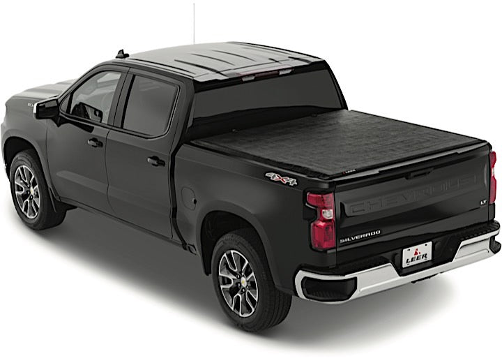 LEER SR250 soft roll-up tonneau cover on a pickup bed: black pickup with a black soft tonneau cover closed over the bed, rear three-quarter view
