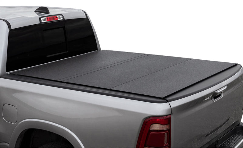 LOMAX Hard Tri-Fold tonneau cover: silver pickup on white, LOMAX hard tri-fold closed, textured black aluminum urethane finish