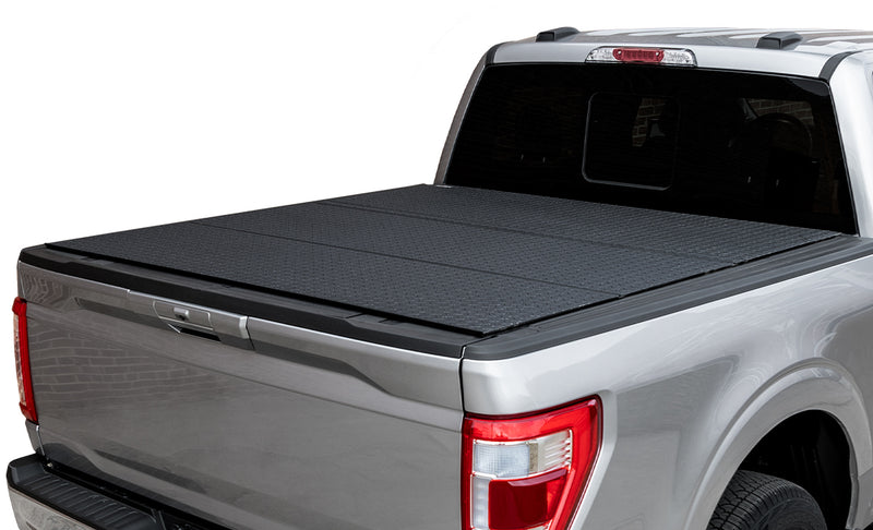 LOMAX Hard Tri-Fold tonneau cover: silver pickup on white, LOMAX tri-fold closed, black diamond-plate urethane finish