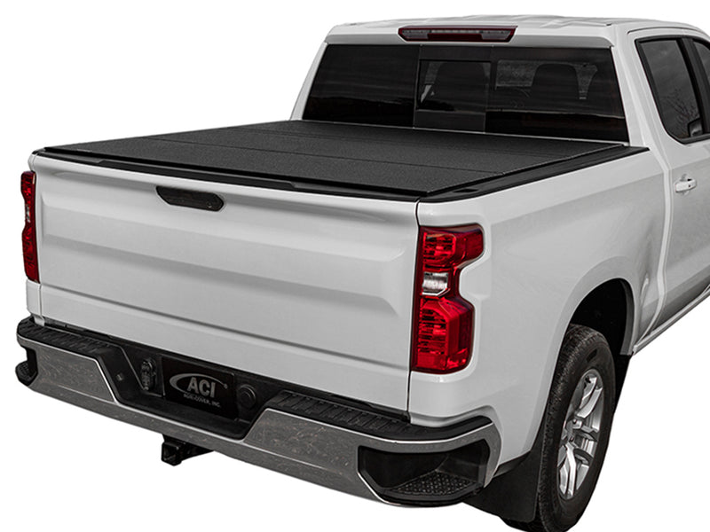 LOMAX Hard Tri-Fold tonneau cover: white pickup on white, tri-fold closed, textured black