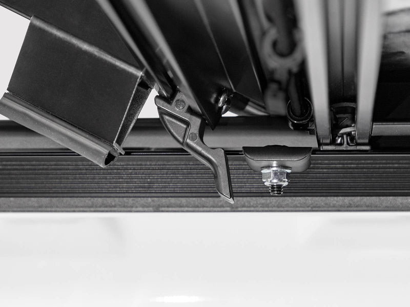 Close-up of the tension lock and hinge hardware on the rail