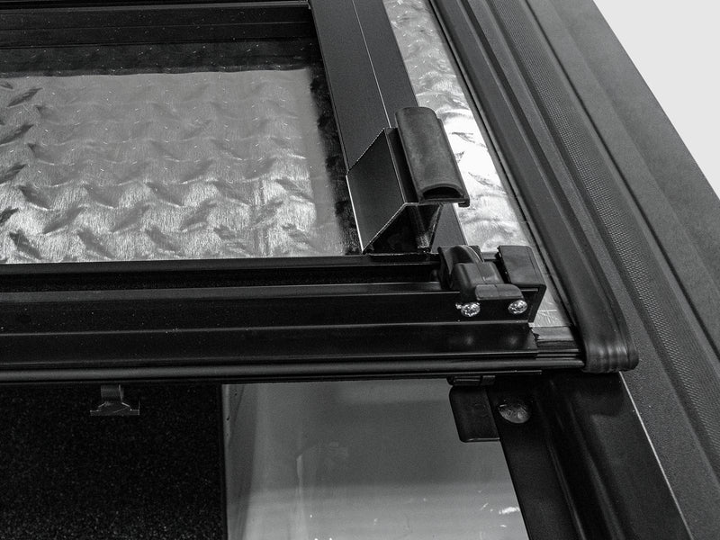 Underside corner of a panel with the hinge and seal against the rail