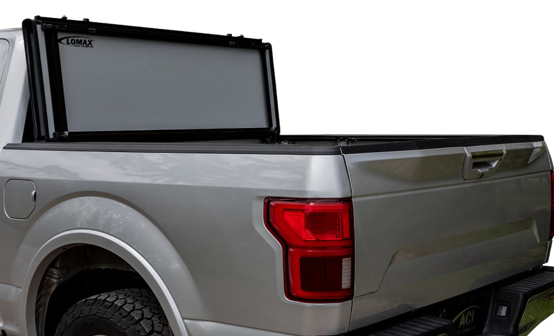 LOMAX STANCE tonneau cover: silver pickup studio cutout side-rear, STANCE panels vertical behind cab with LOMAX decal