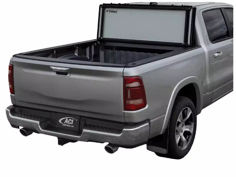 LOMAX STANCE tonneau cover: silver pickup studio cutout, STANCE panels stood vertical against the cab, bed and tailgate exposed