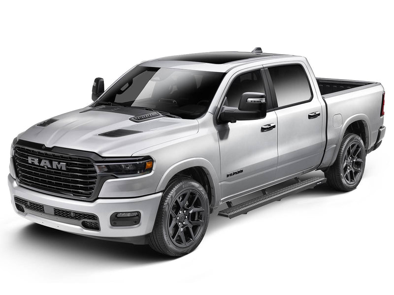 Front three-quarter view of a silver pickup fitted with N-Fab Growler Fleet grip-plate side steps