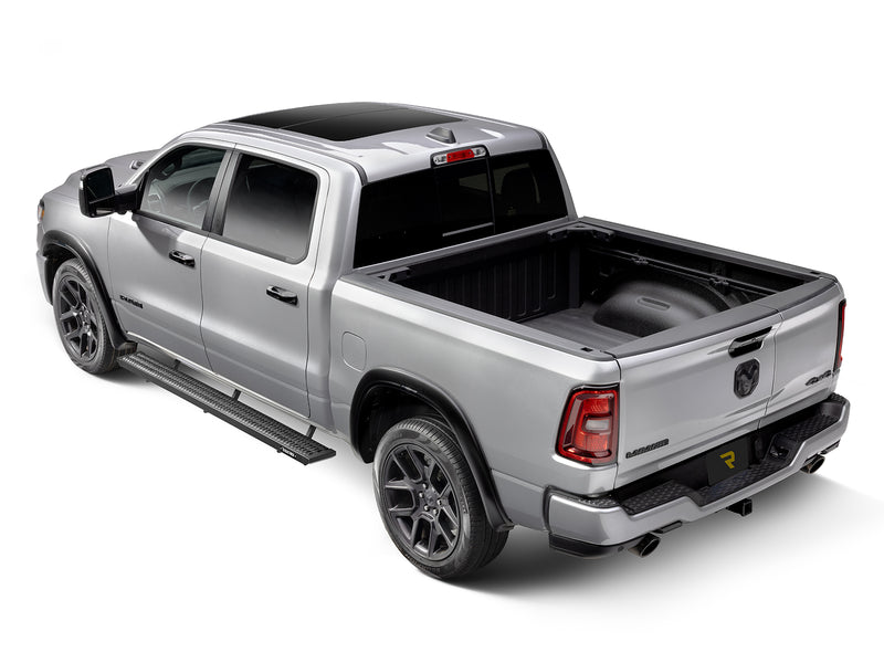 N-Fab Growler Fleet side steps in textured black, rear three-quarter view, installed along the rocker, on a Ram 1500