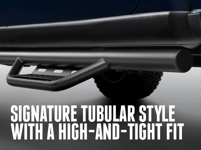 Low view of the N-Fab Nerf Step RS tube and hoop step under a pickup, captioned Signature tubular style with a high-and-tight fit