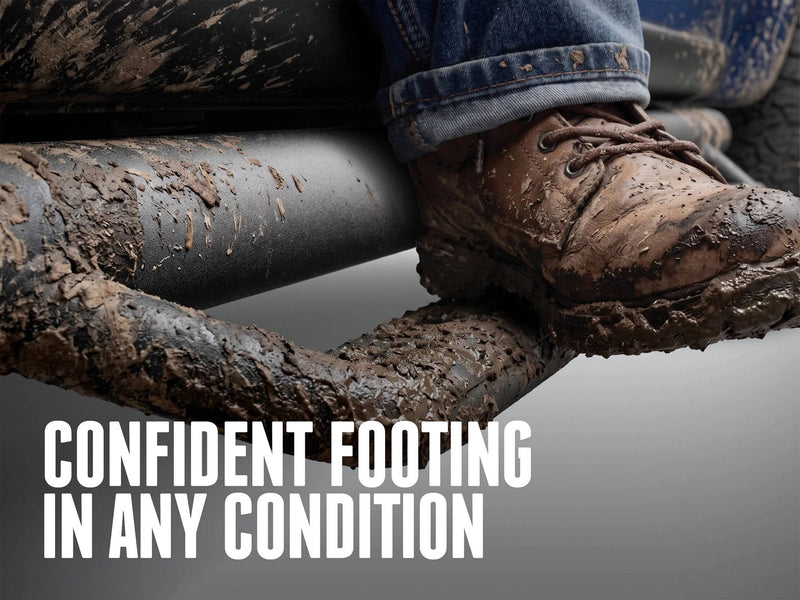 Muddy boot on a textured black N-Fab hoop step, captioned Confident footing in any condition