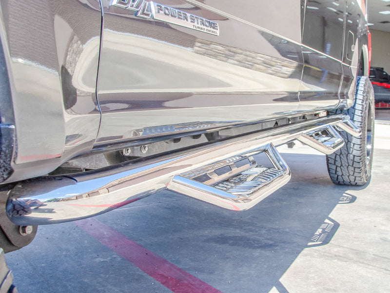 N-Fab Podium bed access nerf step bars in polished stainless, low view, installed along the rocker