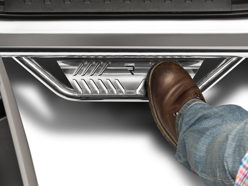 N-Fab Podium cab length nerf step bars in polished stainless, boot on the step at an open door