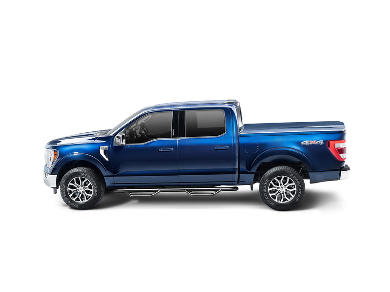 N-Fab Podium cab length nerf step bars in textured black, side profile, shown with a bed cover (not included)