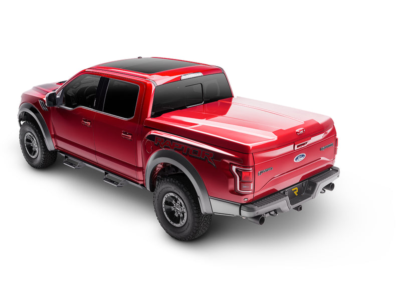 N-Fab Predator Pro nerf steps in textured black, rear three-quarter view, shown with a bed cover (not included)