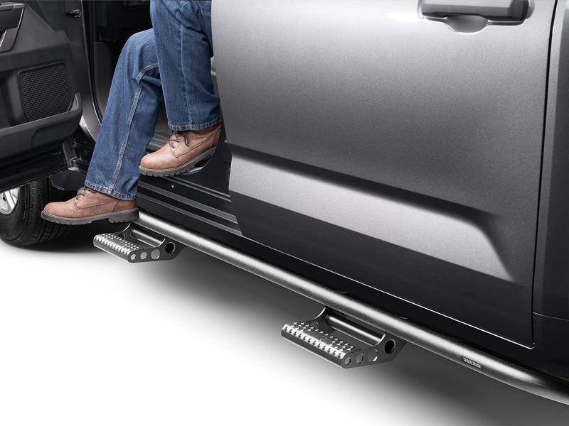 N-Fab RKR Step System in textured black, boot on the step at an open door