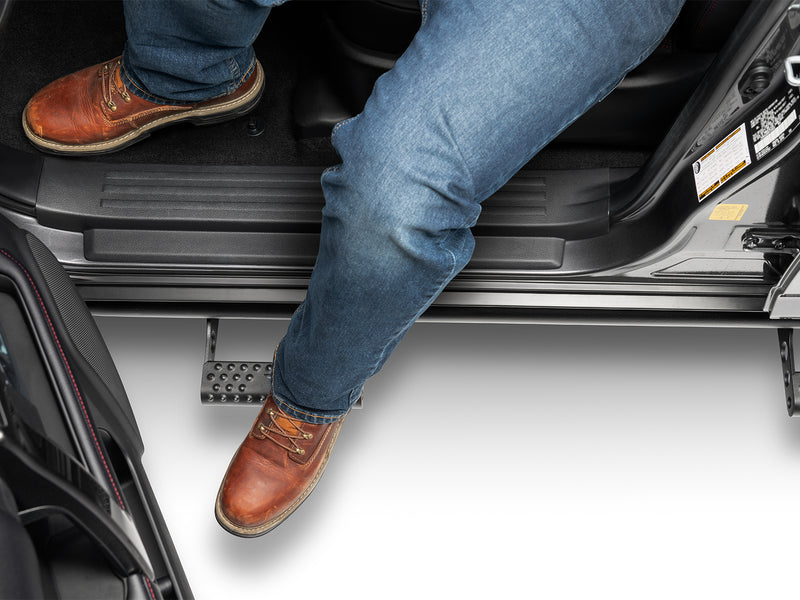 N-Fab RKR Step System in textured black, boot on the step at an open door, on a Toyota 4Runner