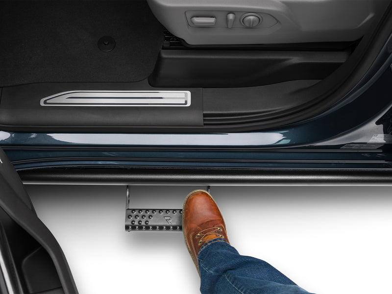 N-Fab RKR Step System in textured black, boot on the step at an open door, on a Chevrolet Silverado 2500 HD