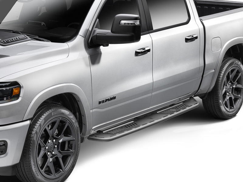 N-Fab Roan running boards in textured black, front three-quarter view, installed along the rocker, on a Ram 1500