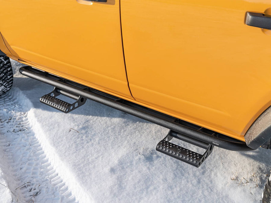 N-Fab RKR Step System in textured black, low view, installed along the rocker in snow