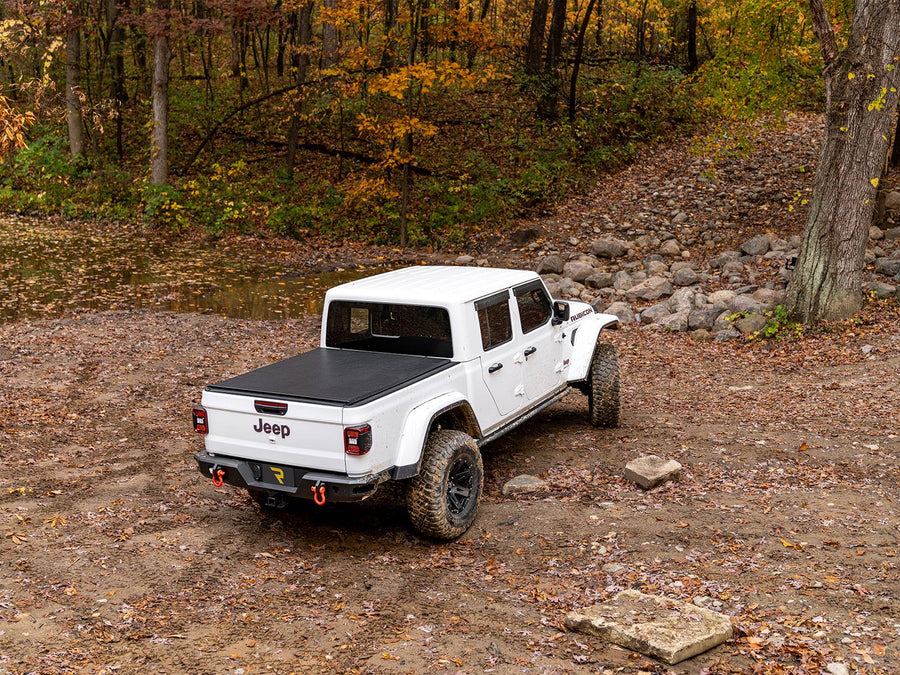 N-Fab TrailSlider step system in textured black, installed, shown with a bed cover and a rear bumper (not included)
