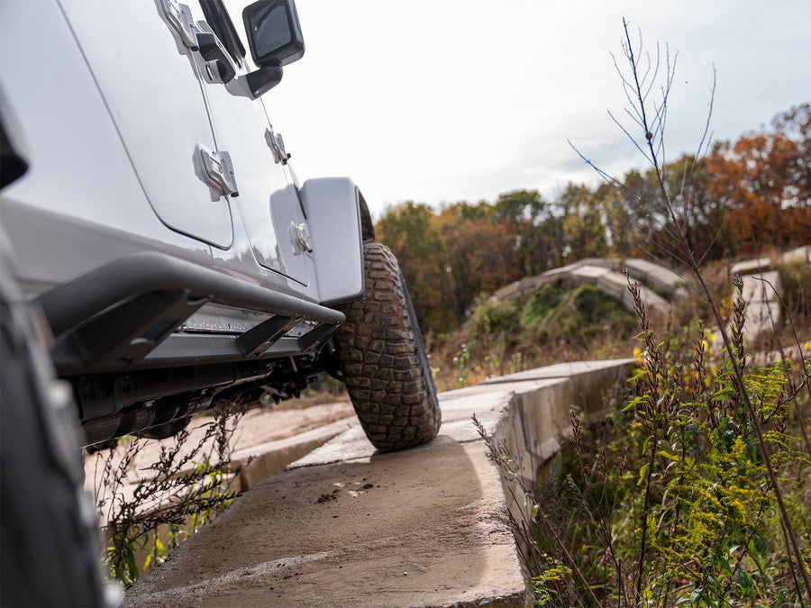 N-Fab TrailSlider step system in textured black, installed along the rocker, vehicle off-road