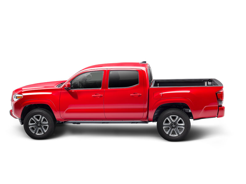 N-Fab TrailSlider step system in textured black, side profile, installed along the rocker, on a Toyota Tacoma