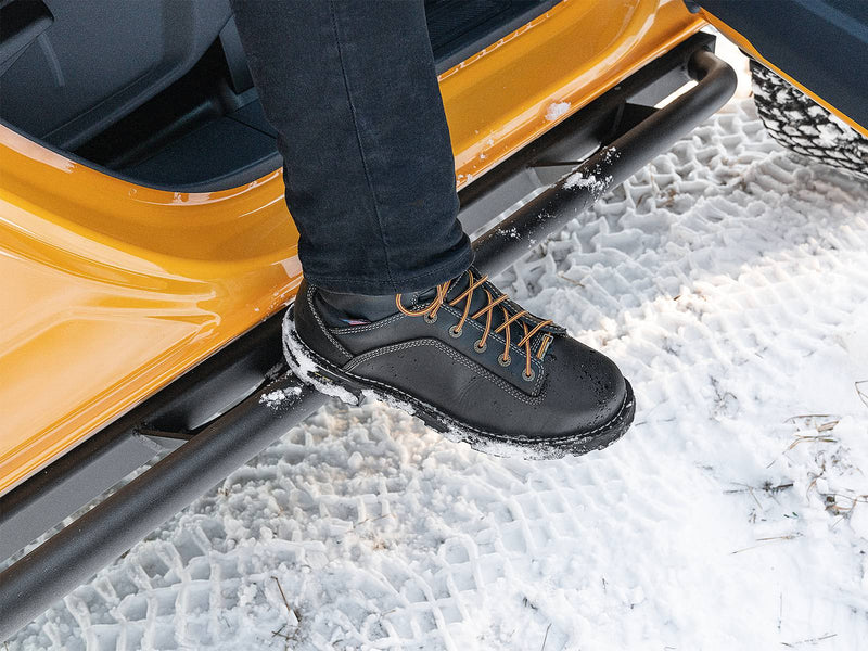 N-Fab TrailSlider step system in textured black, boot on the step at an open door