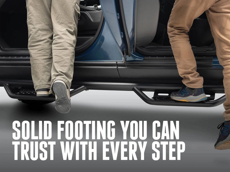 Two people stepping on N-Fab Nerf Step RS hoop steps below the doors, captioned Solid footing you can trust with every step