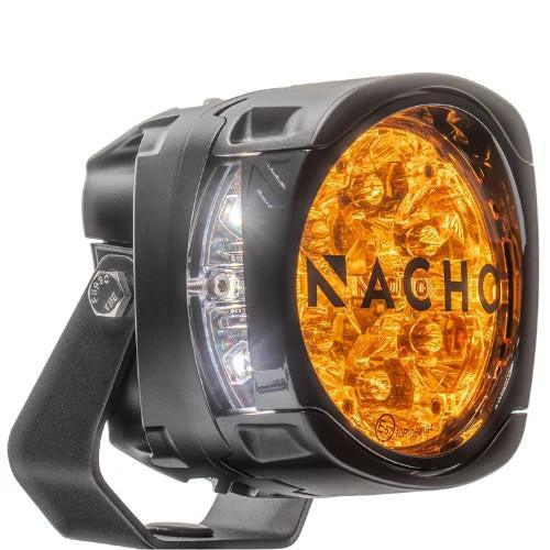 NACHO Quatro light with the supplied amber cover fitted over the lens, the orange tint showing the optics behind it and NACHO lettering across the cover, with the white Trail Running Light element visible at the side