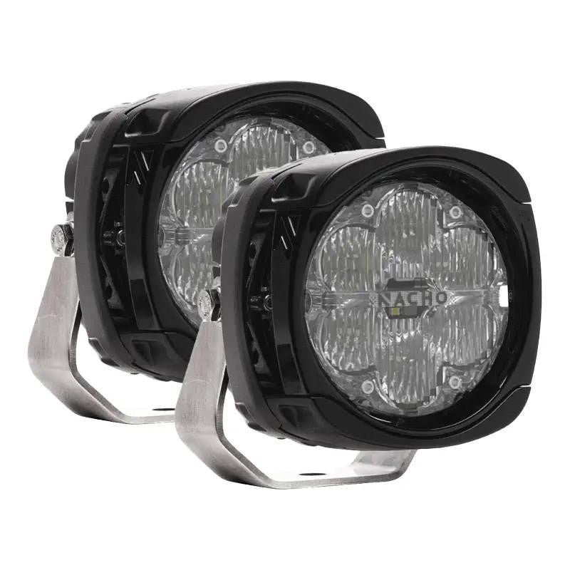 Pair of NACHO Quatro flood LED auxiliary lights on white, squared black housings with clear lenses over lenticular diffusing optics, NACHO lettering across each lens and stainless mount brackets