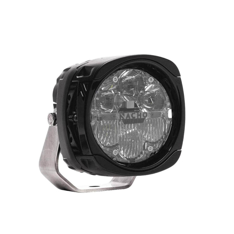 NACHO Quatro SAE LED auxiliary light at an angle, squared black housing with a clear lens over four round reflectors and a lower fog optic section, SAE and DOT compliance markings etched into the lens beside the NACHO lettering