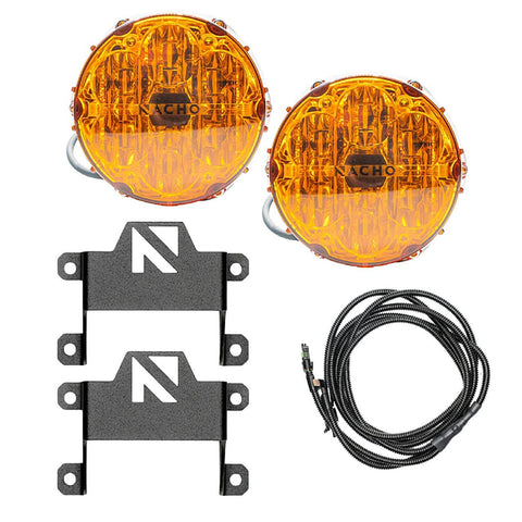 NACHO plug and play fog light kit contents on white: two amber-lens Quatro SAE round lights with pigtail leads, two tall black brackets with the NACHO N logo cut-out, and a coiled loomed harness