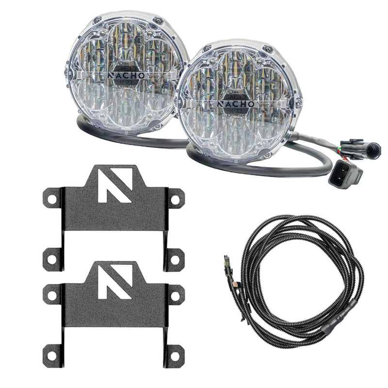 NACHO plug and play fog light kit contents on white: two clear-lens Quatro SAE round lights with pigtail leads and OEM connectors, two tall black brackets carrying the NACHO N logo cut-out, and a coiled loomed harness