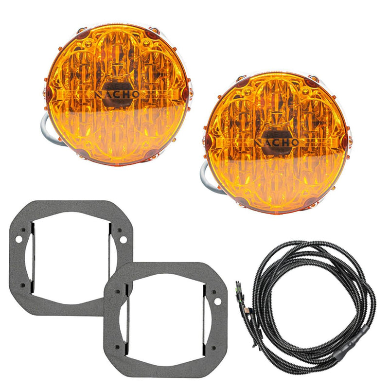 NACHO plug and play fog light kit contents on white: two amber-lens Quatro SAE round lights with pigtail leads, two flat black bracket plates with rectangular apertures, and a coiled loomed harness