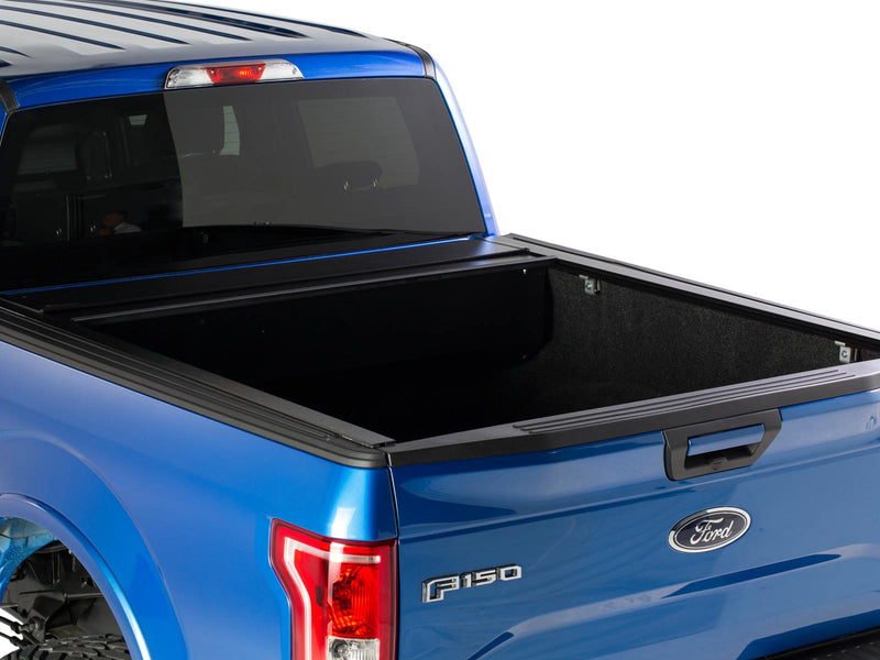 Pace Edwards BedLocker: blue pickup bed with the black retractable cover fully retracted into the front canister