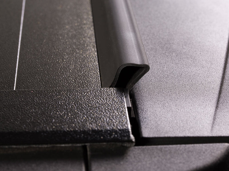 Pace Edwards BedLocker: close-up of a black aluminum cover slat edge and rubber seal profile