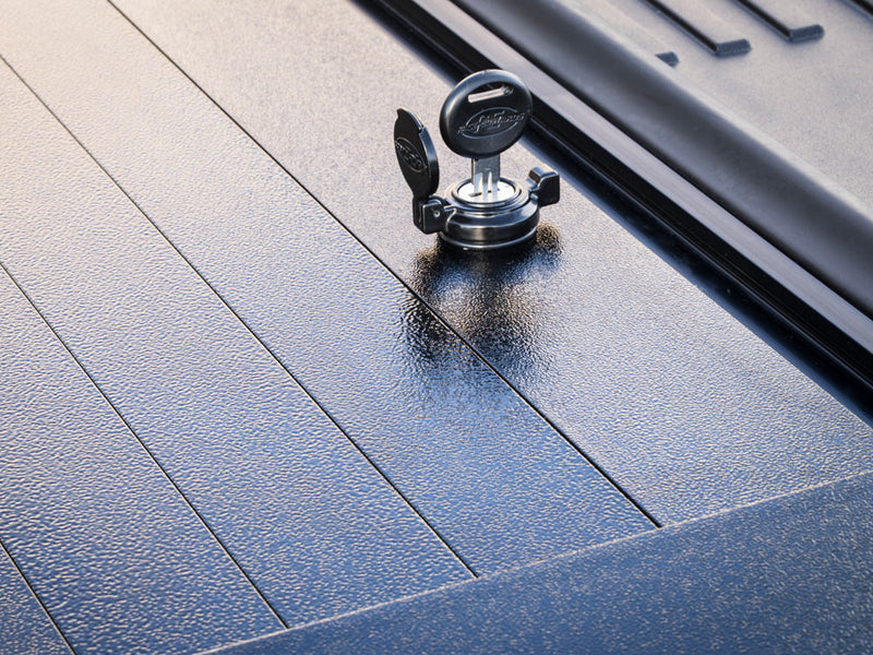Pace Edwards Full Metal JackRabbit: close-up of a keyed lock with its cap open on textured black metal slats