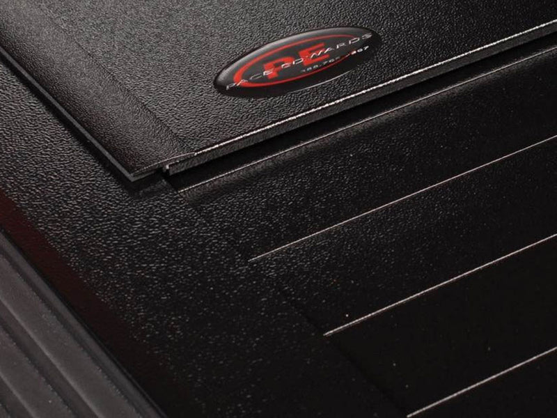 Pace Edwards Full Metal JackRabbit: close-up of a textured black canister lid with an oval Pace Edwards badge