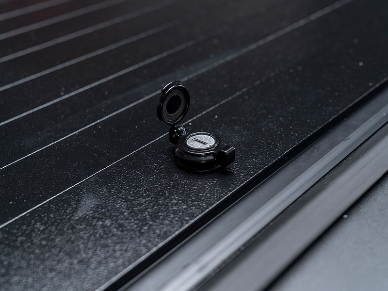 Pace Edwards Full Metal JackRabbit: close-up of the keyed lock with its cap flipped open on black metal slats