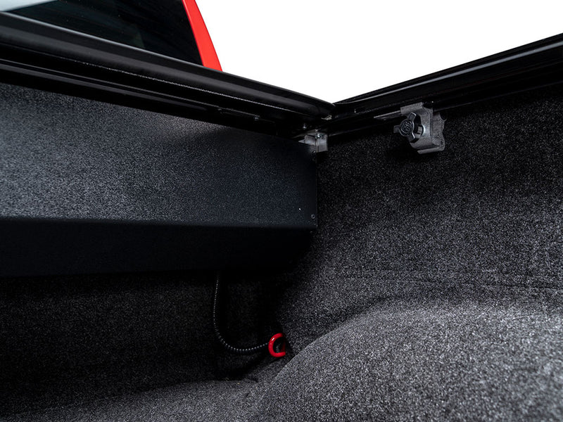 Pace Edwards Full Metal JackRabbit: front of the bed showing the black canister, rail corners and drain tube, carpet liner