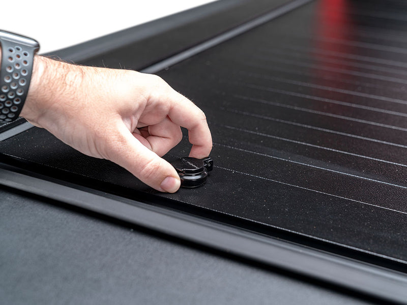 Pace Edwards Full Metal JackRabbit: hand turning the lock on black metal slats beside the side rail