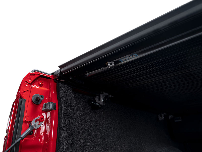 Pace Edwards Full Metal JackRabbit: view under the closed cover at the tailgate end showing the side rail and clamp, red bed