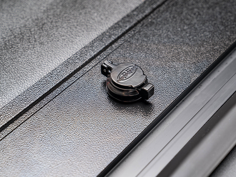 Pace Edwards JackRabbit: capped key lock on the textured black end slat of a closed cover